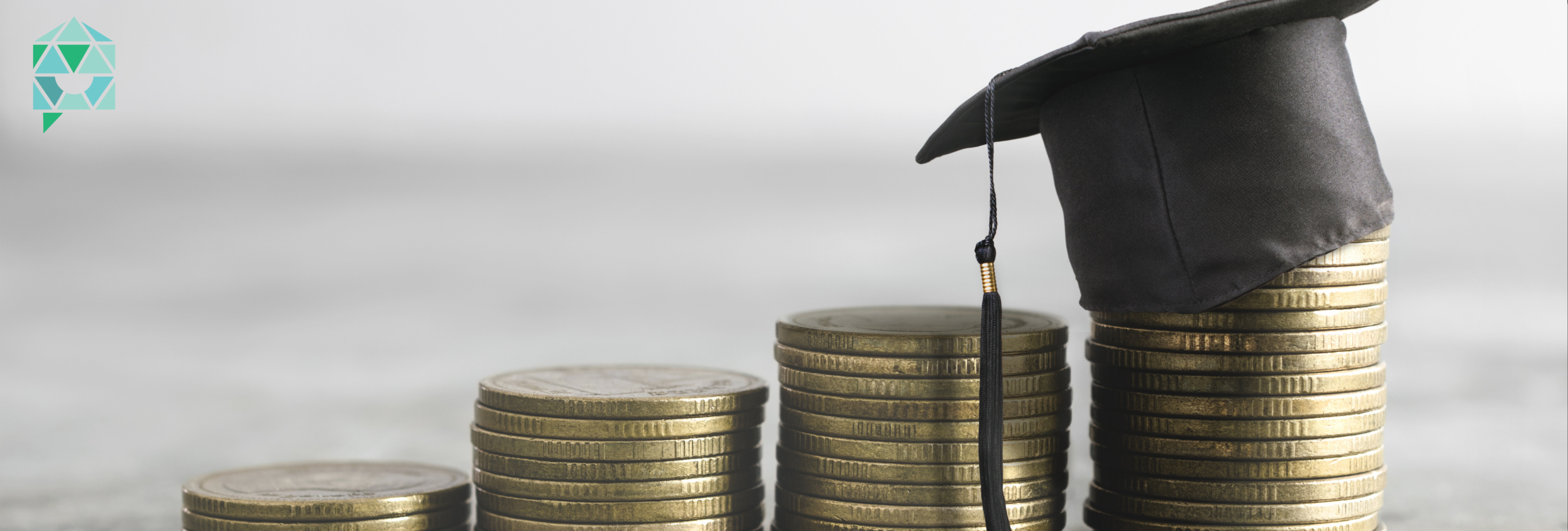 Four stacks of coins are arranged in ascending order of height, from left to right. The leftmost stack has the fewest coins, and the rightmost stack has the most coins. On top of the rightmost stack, there is a graduation cap with a tassel.