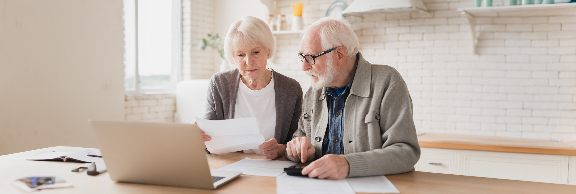 elderly couple reading paper